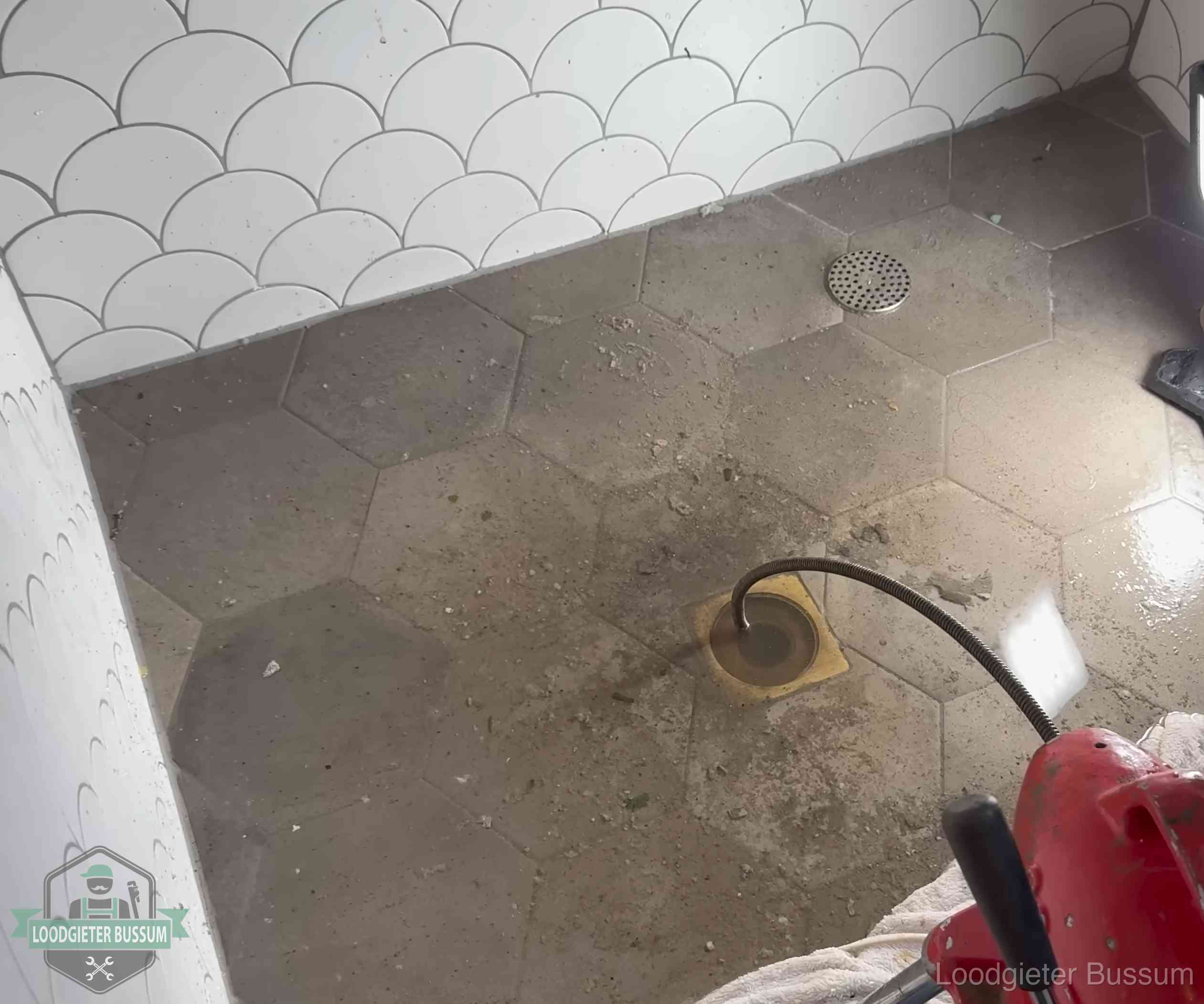 Vloerput met waterslot in een badkamer in Bussum, een bron van stank als het waterslot droogstaat